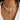 Elegant pearl necklace featuring gold starfish and seashell charms, worn around the neck.