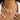 Elegant pearl necklace featuring gold starfish and seashell charms, worn around the neck.