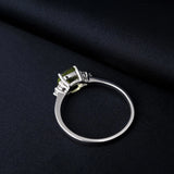 Sterling silver ring with a cushion-cut green peridot gemstone and small diamonds.