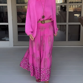 Pink boho skirt paired with an oversized sweater, showcasing women's spring fashion with a focus on bright magenta and pink hues.
