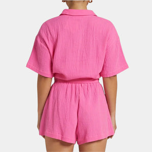 Pink crinkle short sleeve high neck romper with a belt, featuring a summer design.
