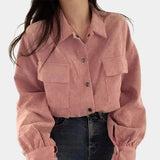 Pink cropped V-neck blouse with puffed sleeves, featuring a casual chic design.