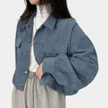 
A blue cropped V-neck blouse with puffed sleeves designed for a casual chic style.