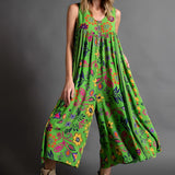 Pink floral bohemian wide-leg jumpsuit with pockets, featuring a relaxed fit, short sleeves, and a comfortable waist, ideal for casual wear or a day out.
