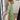 Pink floral maxi dress with a v-neck design, featuring a summer garden pattern. The dress is displayed in a green color variant and is size XL. It showcases a flowing one-piece garment style with sleeves, extending down to the knees, accentuating the waist. The dress is positioned against the backdrop of a door.
