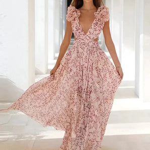 Pink floral maxi dress featuring a V-neckline, ruffle sleeves, and a high-waist design worn by a smiling woman.