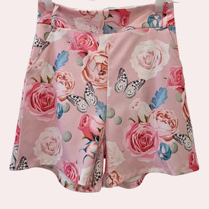 Pink floral skirt with rose and butterfly print, featuring a summer fashion design for women, highlighting intricate patterns and vibrant pink and peach hues.