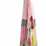 A pink geometric cape dress featuring long sleeves, an asymmetric design, and a flowing silhouette, suitable for evening wear. The dress highlights the shoulder and waist with its unique fashion design, extending to the thigh.