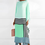 Blue geometric cape dress with long sleeves, featuring an asymmetrical design suitable for evening wear.