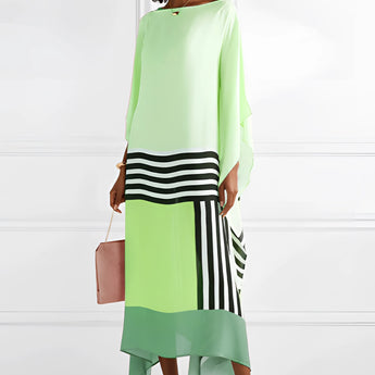 Green geometric cape dress with long sleeves and an asymmetric design, featuring a structured shoulder, fitted waist, and knee-length hem.