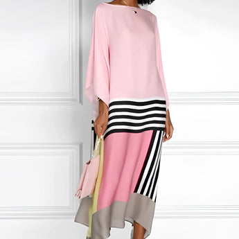 Pink geometric cape dress with long sleeves and an asymmetric design, suitable for evening wear, shown in size 2XL.