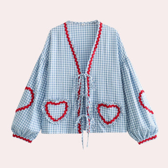Pink gingham puff sleeve blouse with ruffle trim, showcasing a classic collar and button details, in a vibrant blue color, size XL.