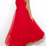 Pink halter neck backless tulle dress with a flowing skirt, perfect for weddings and summer events, modeled by a smiling woman.