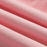 Close-up image of pink lightweight moisture-wicking athletic wear fabric, showcasing its soft texture and subtle pattern. The fabric features various pink shades, including magenta and peach tones.