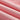 Close-up image of pink lightweight moisture-wicking athletic wear fabric, showcasing its soft texture and subtle pattern. The fabric features various pink shades, including magenta and peach tones.