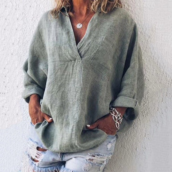 Pink oversized V-neck linen blouse for women, showcasing a relaxed fit, suitable for spring, paired with jeans, featuring long sleeves and a comfortable textile.