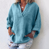 Blue oversized V-neck linen blouse for women, featuring a relaxed fit with long sleeves and a comfortable shoulder design.
