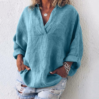 Blue oversized V-neck linen blouse for women, featuring a relaxed fit with long sleeves and a comfortable shoulder design.