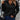 Pink ribbed high-neck slim fit sweater for women, styled with jeans, showcasing streetwear fashion with detailed attention to shoulder and sleeve design.