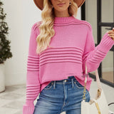 Pink textured ribbed sweater featuring a stylish cut-out design, displayed on a mannequin. The knitwear showcases long sleeves and a high neckline, highlighting the modern fashion-forward design in an XL size.
