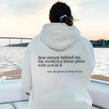 A pink tie-dye hoodie with a self-love motivational quote printed on the front displayed against a serene background, showcasing its cozy long sleeves and vibrant colors.