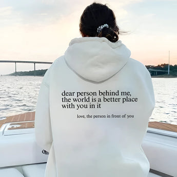 A pink tie-dye hoodie with a self-love motivational quote printed on the front displayed against a serene background, showcasing its cozy long sleeves and vibrant colors.