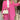 Woman wearing a pink trouser suit with high-waist pants, a blazer, and a crop top, standing in a stylish pose.