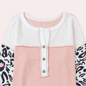Toddler pink and white dress featuring a Peter Pan collar with animal print sleeves.