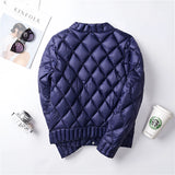
A pink women's lightweight quilted jacket featuring a diamond pattern with long sleeves, displayed against a neutral background.