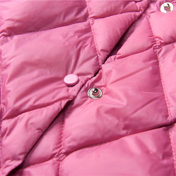 A pink women's lightweight quilted jacket featuring a diamond pattern, displayed against a neutral background. The jacket emphasizes comfort with its soft fabric and vibrant pink hue.