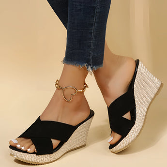 Pink women's espadrille wedge sandals with a suede strap and ankle chain, shown on a model's foot, highlighting the stylish design and comfortable fit.