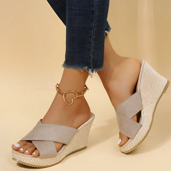 Pink women's espadrille wedge sandals with suede strap and ankle chain being worn, showcasing a stylish and fashionable design.