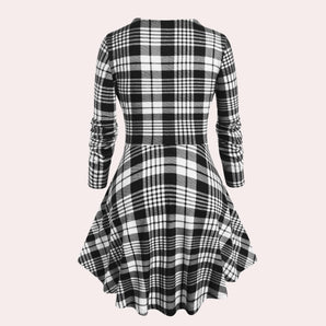 Black and white checkered plaid dress with long sleeves and knee-length design, featuring a classic collar.