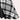 Black and white checkered plaid dress with long sleeves and a knee-length hem, featuring a collar.