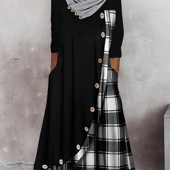 Plaid long-sleeve midi dress featuring a cowl neck and contrast hem, with a focus on the shoulder and waist detailing.