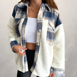 A woman wearing a blue plaid Sherpa jacket with fleece lining, featuring long sleeves and a cozy collar, suitable for winter fashion.