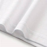 Plain white unisex t-shirt with short sleeves and a minimalist design, displayed on a flat surface.