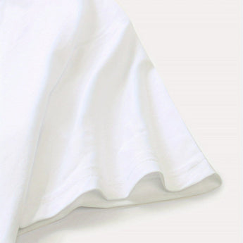 Plain white unisex t-shirt with short sleeves displayed on a hanger in a minimalistic setting.