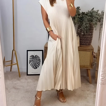 Pleated maxi dress in taupe with cap sleeves, designed for summer wear; shown in beige color and size 3XL, highlighting the dress's waist and shoulder details.