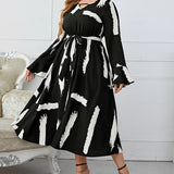 Plus size abstract print midi dress with long sleeves and tie waist, modeled by fashion model with long hair, suitable for party attire or formal events.
