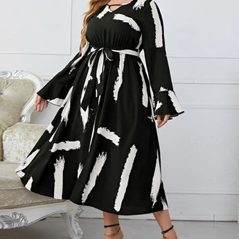 Plus size abstract print midi dress with long sleeves and tie waist, modeled by fashion model with long hair, suitable for party attire or formal events.