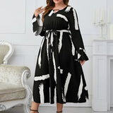 Plus size abstract print midi dress with long sleeves and tie waist, ideal for party attire.