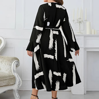 Plus size abstract print midi dress with long sleeves and tie waist, suitable for party attire.