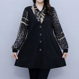 
A plus size black tunic featuring polka dot sleeves and a bow tie neck, showcased by a fashion model. The tunic highlights key areas such as the shoulder, neck, and waist.