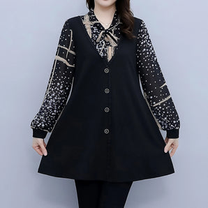 
A plus size black tunic featuring polka dot sleeves and a bow tie neck, showcased by a fashion model. The tunic highlights key areas such as the shoulder, neck, and waist.