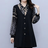 
Alt Text: Plus size black tunic featuring white polka dot sleeves and a bow tie neck, designed in an XL size.