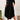 Plus size black loose fit midi dress with short sleeves and a round neck, designed for a casual summer look. The dress is oversized and falls to a mid-length, offering a comfortable and fashionable fit for size 2XL. The model is standing, showcasing the dress's relaxed style.