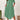 Plus size light green loose fit midi dress shown in an oversized casual summer style, featuring short sleeves and a relaxed waist, perfect for standing comfortably.