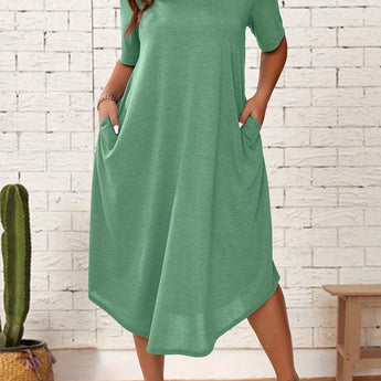 Plus size light green loose fit midi dress shown in an oversized casual summer style, featuring short sleeves and a relaxed waist, perfect for standing comfortably.