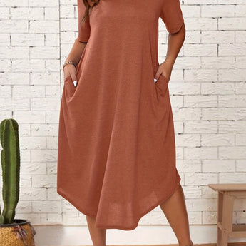 
A plus size orange-red loose fit midi dress featuring short sleeves, a round neckline, and a relaxed silhouette suitable for casual summer wear. The dress includes a waistline detail and is shown on a standing model.